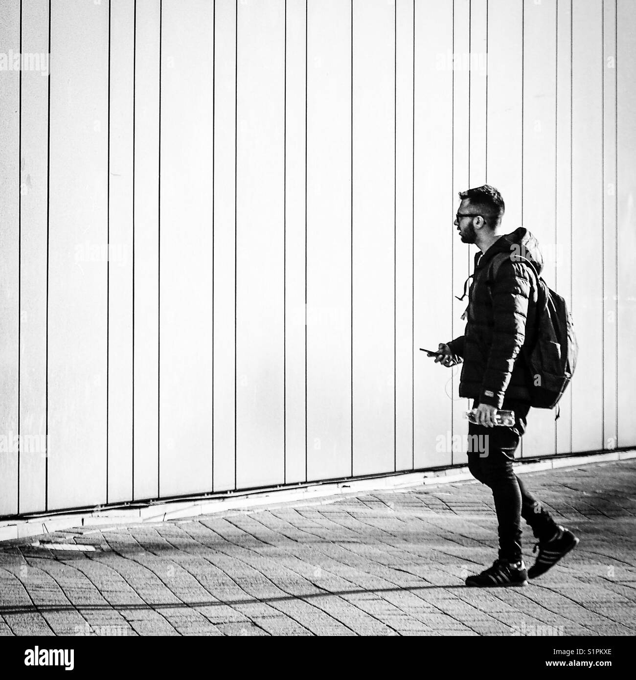 Man walking backpack not hiking Black and White Stock Photos & Images ...