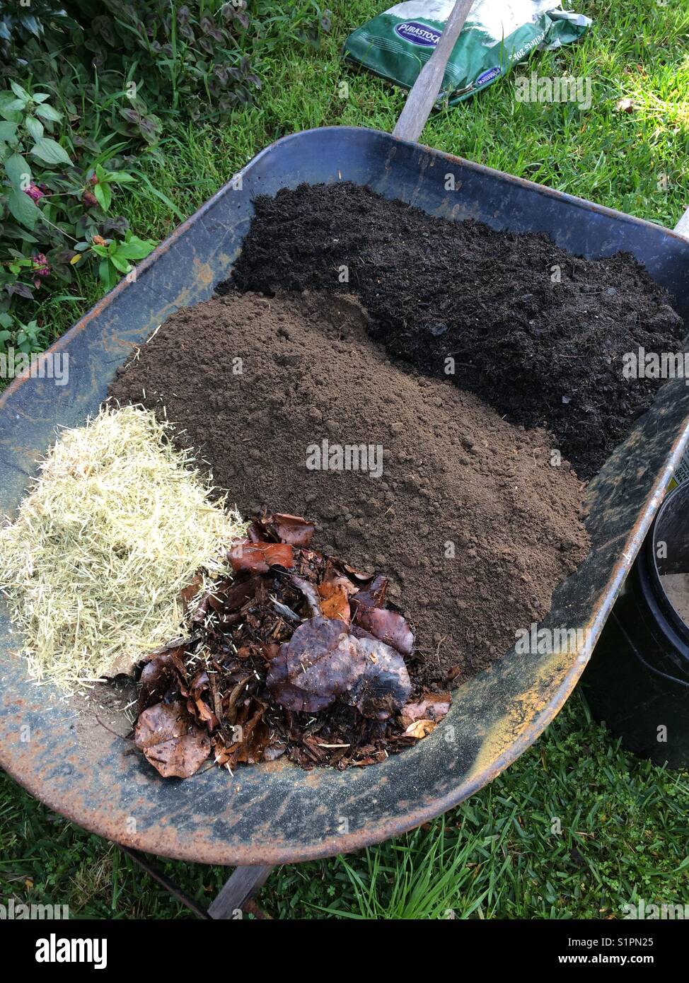 Making Garden Soil Mix In A Wheelbarrow With Compost Manure And