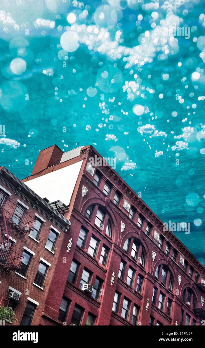 And abstract image of a red building in New York City with the blues guy that looks like water Stock Photo