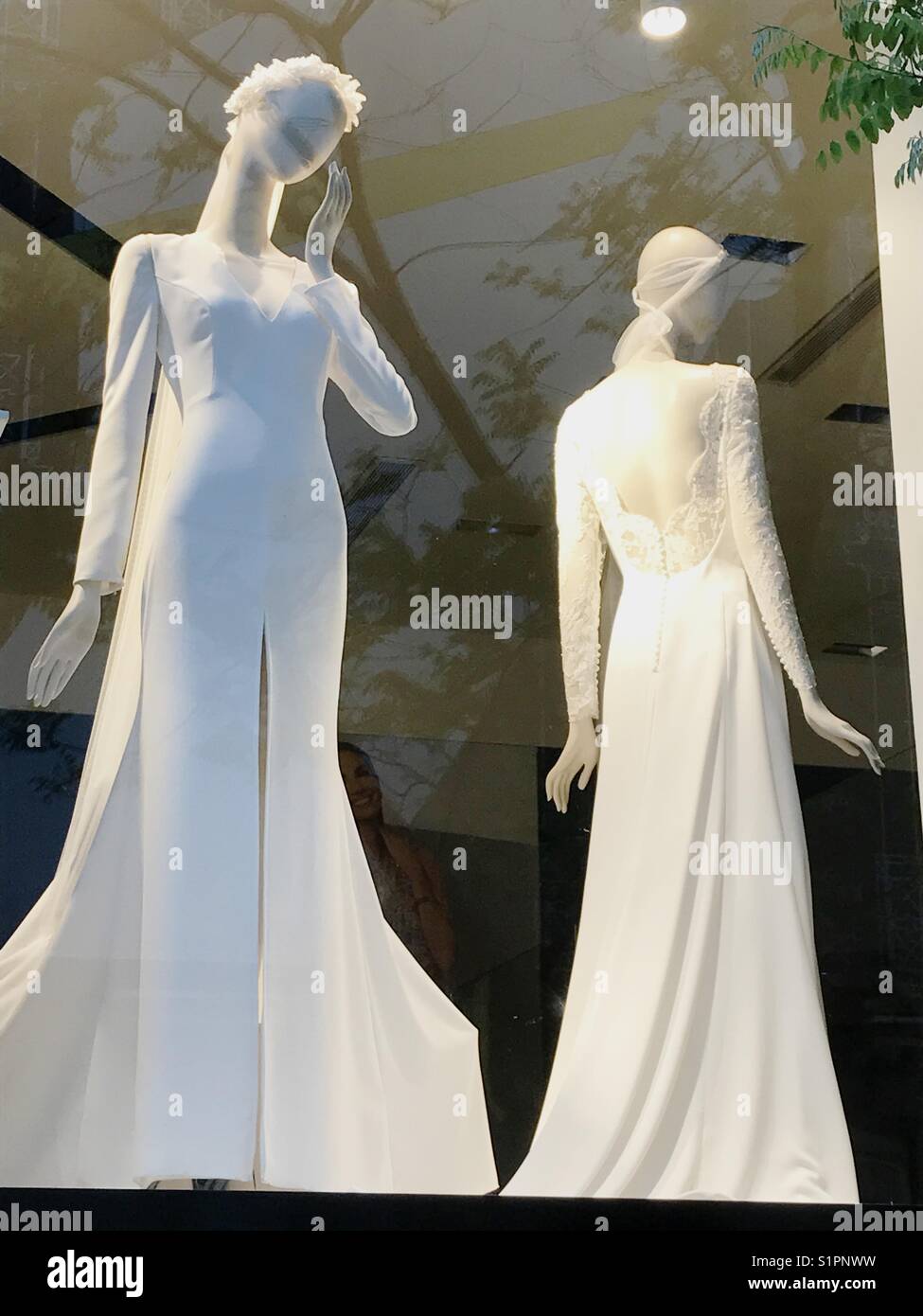 Two mannequins wearing wedding dresses in a shop window. Madrid. Spain. - Smartphone Captured Stock Image
