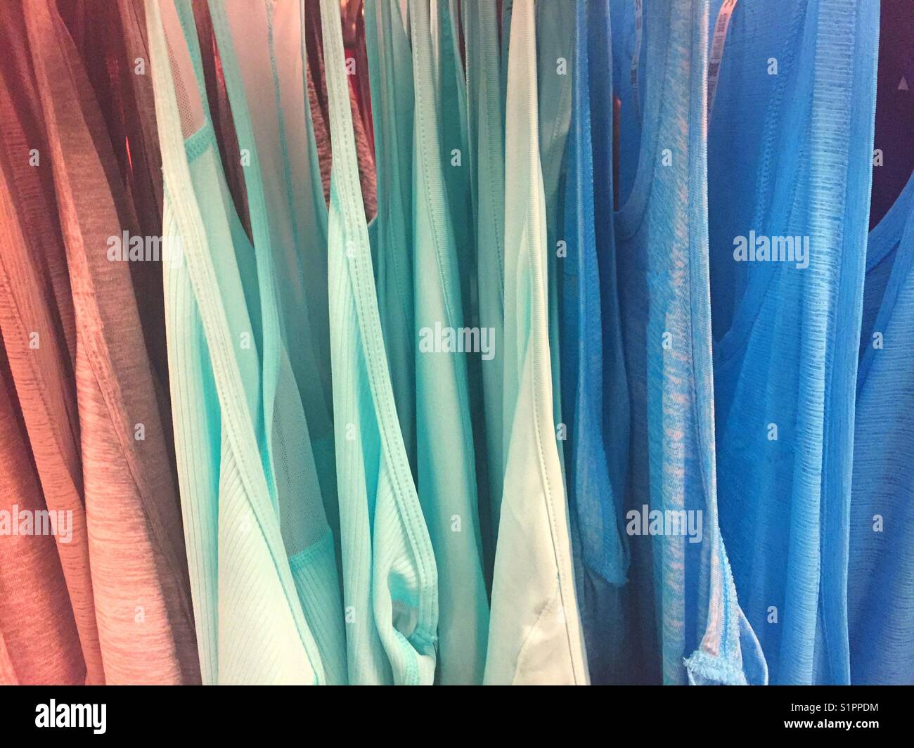 Colorful clothing hanging in a row. Abstract. Stock Photo