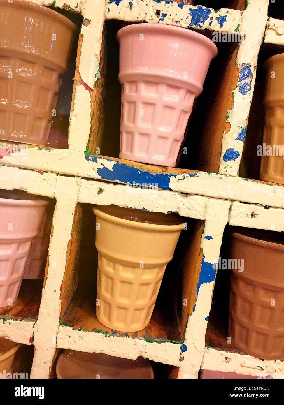 Ceramic multi colored ice cream cone shaped glassware, for sale in retail store, United States, USA - Smartphone Captured Stock Image