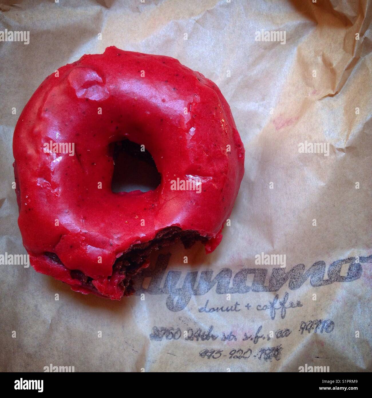 Chocolate Raspberry vegan donut at Dynamo Donuts on 24th Street in The Mission in San Francisco. - Smartphone Captured Stock Image