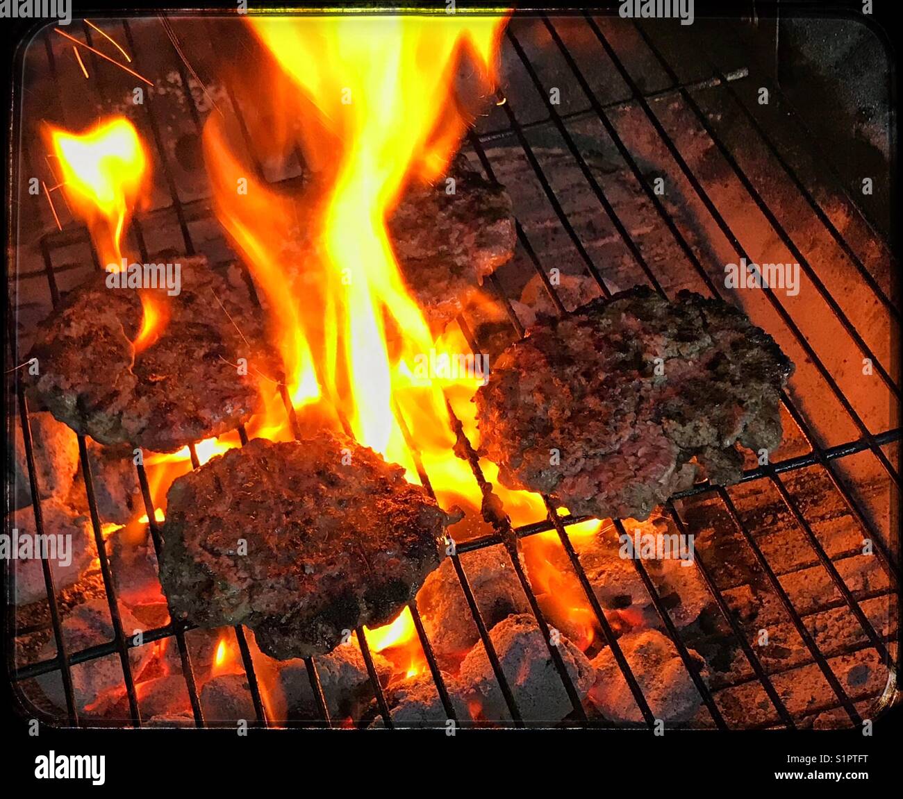 Barbecue beef burgers on flame hi-res stock photography and images - Alamy