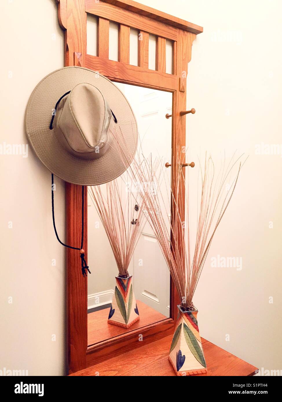 Entry hall mirror with happy rack and hat, USA - Smartphone Captured Stock Image