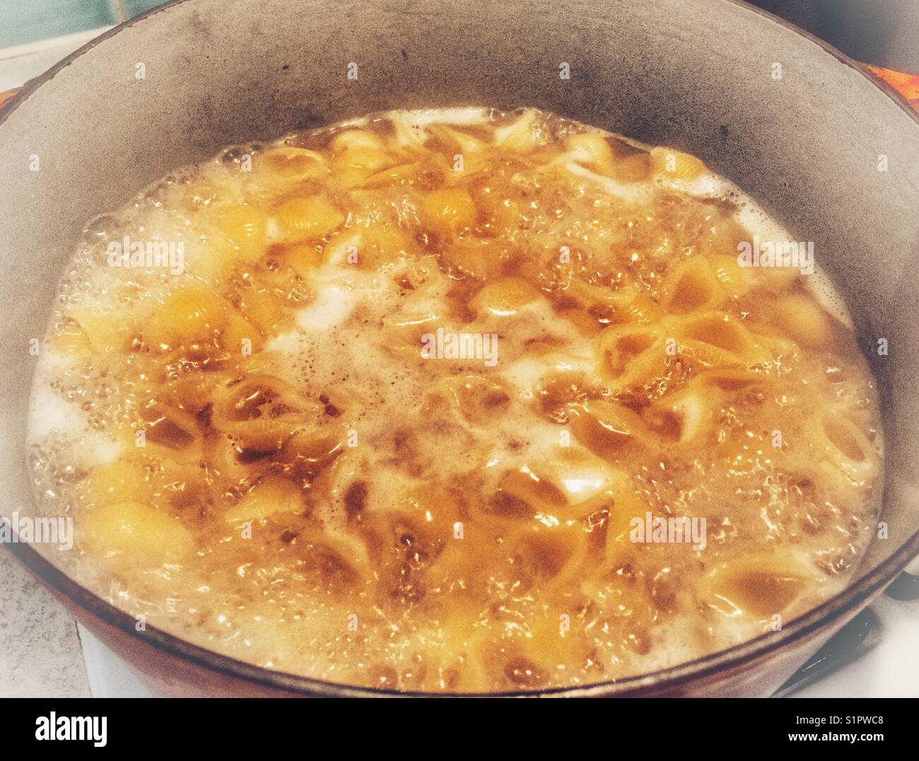 Pasta cooking in boiling water Stock Photo