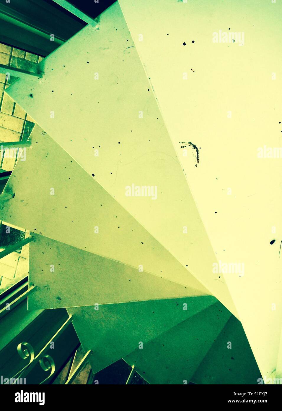 Looking down dirty white spiral staircase - Smartphone Captured Stock Image