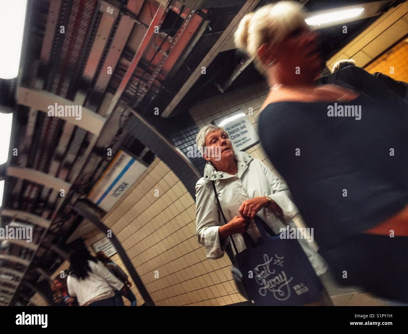 Travelling on the London underground at Victoria station, England - Smartphone Captured Stock Image