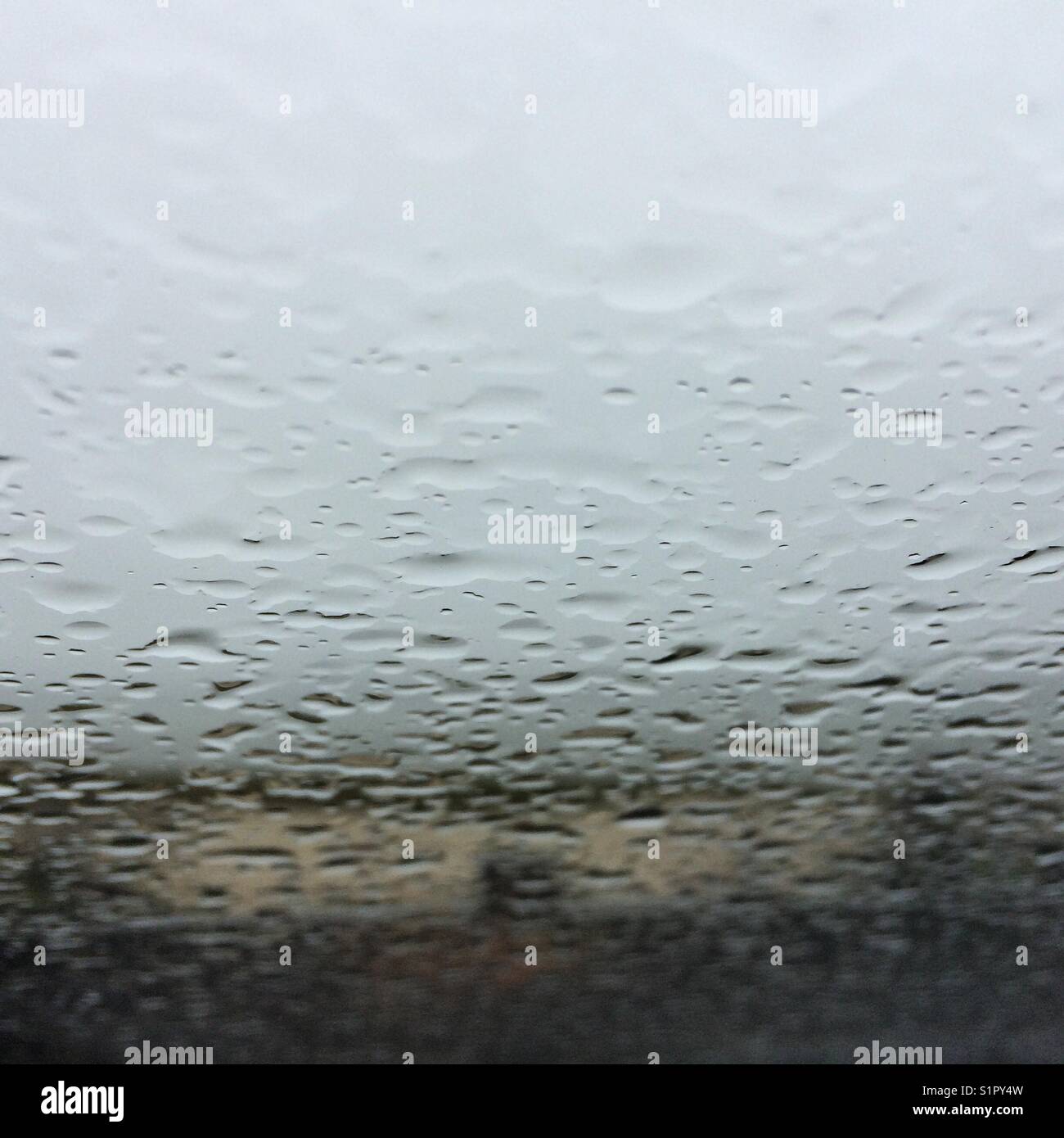 Looking towards the beach through the windshield on a rainy day Stock Photo