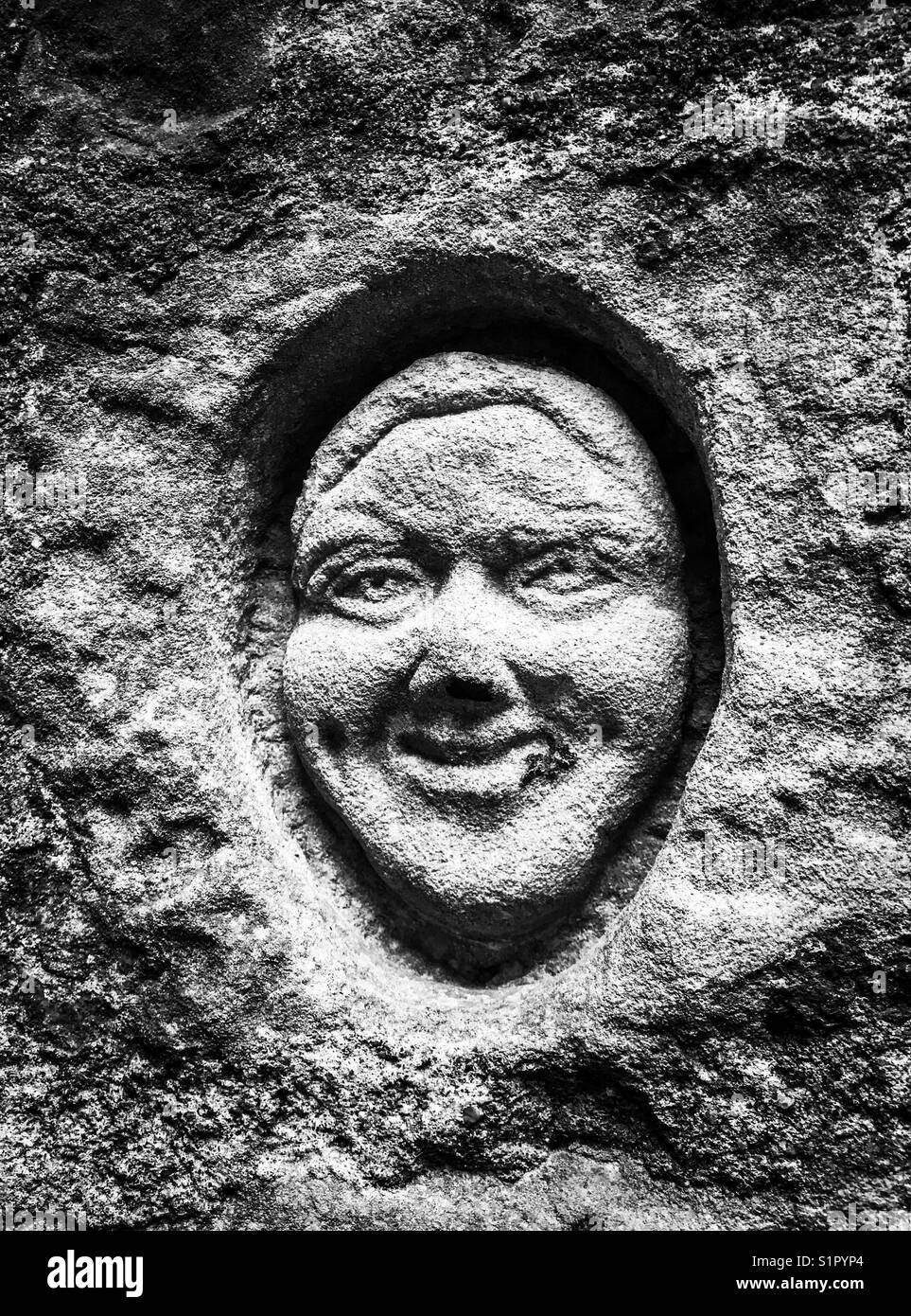 Stone face in wall Stock Photo Alamy