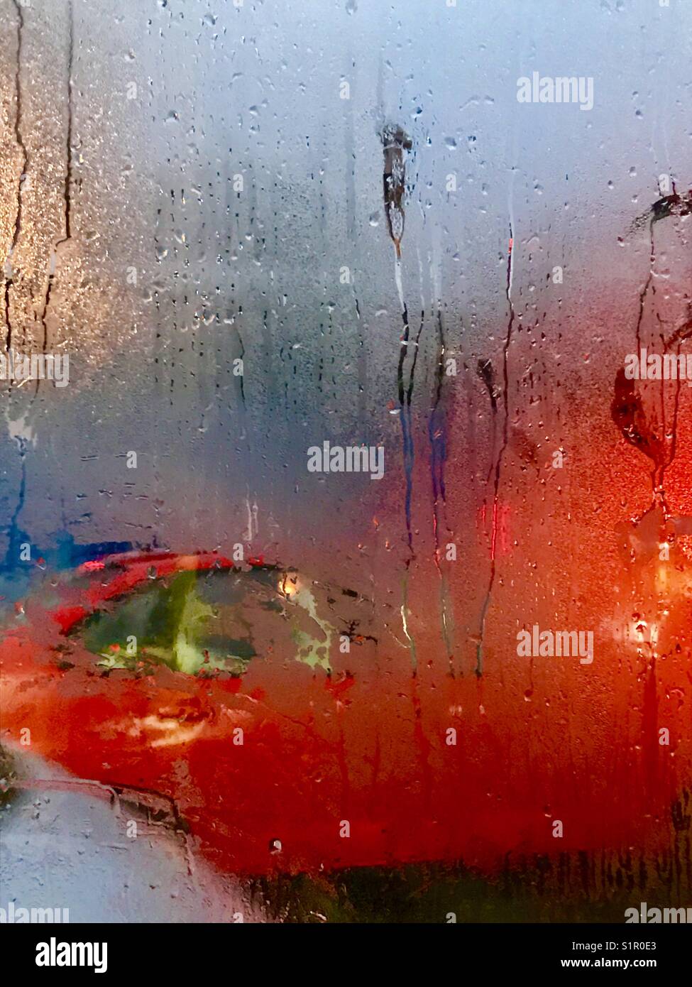 Traffic in a rainy day.  View through a car window. - Smartphone Captured Stock Image