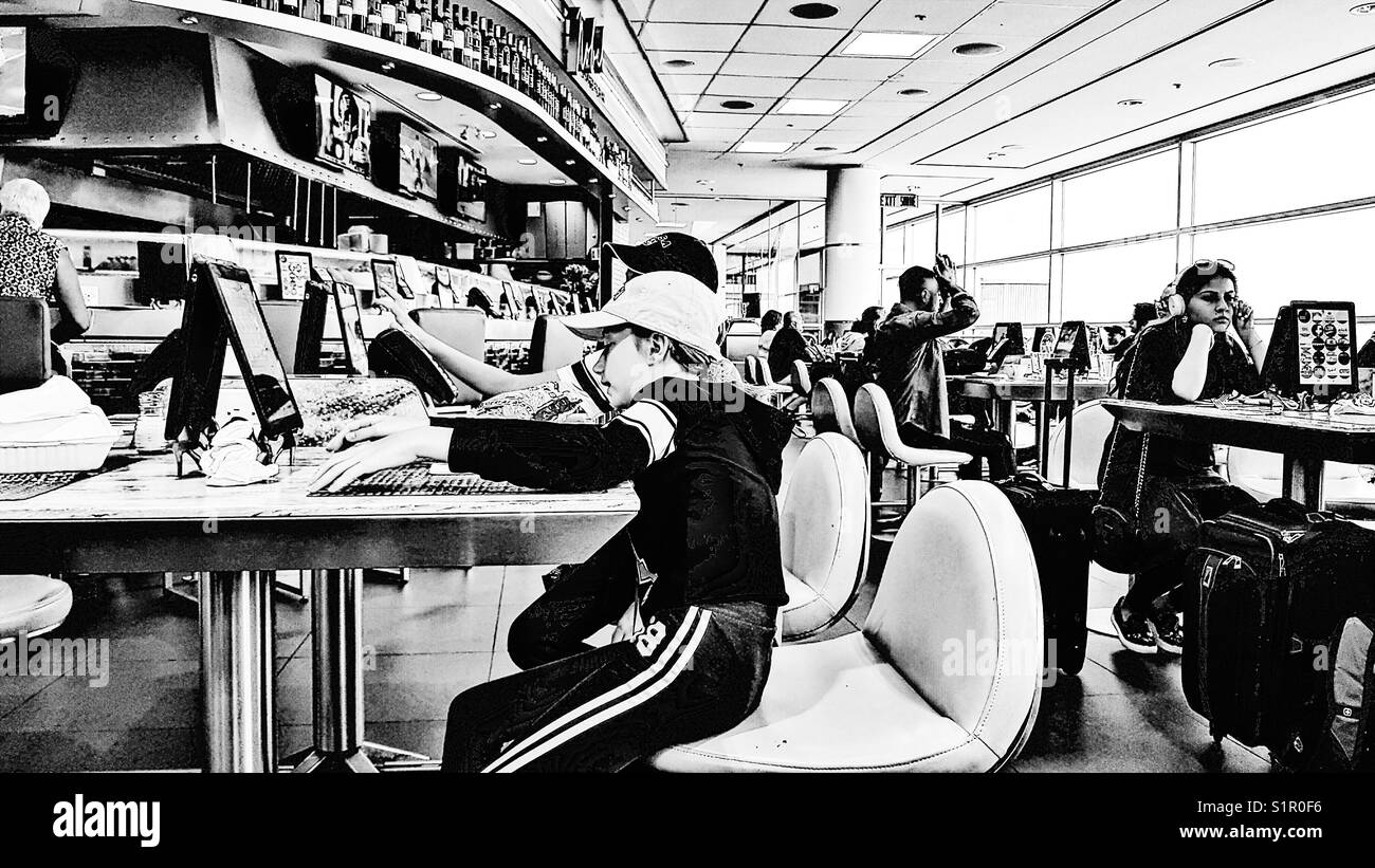 Passengers on tablets at Toronto Pearson International airport, Toronto, Ontario, Canada Stock Photo