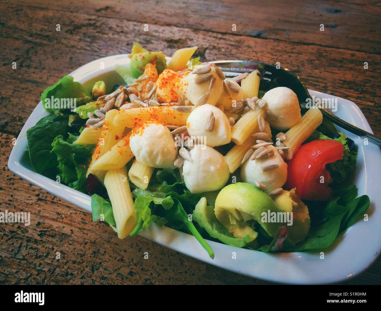Vegetarian mozzarella salad on a wooden table - Smartphone Captured Stock Image