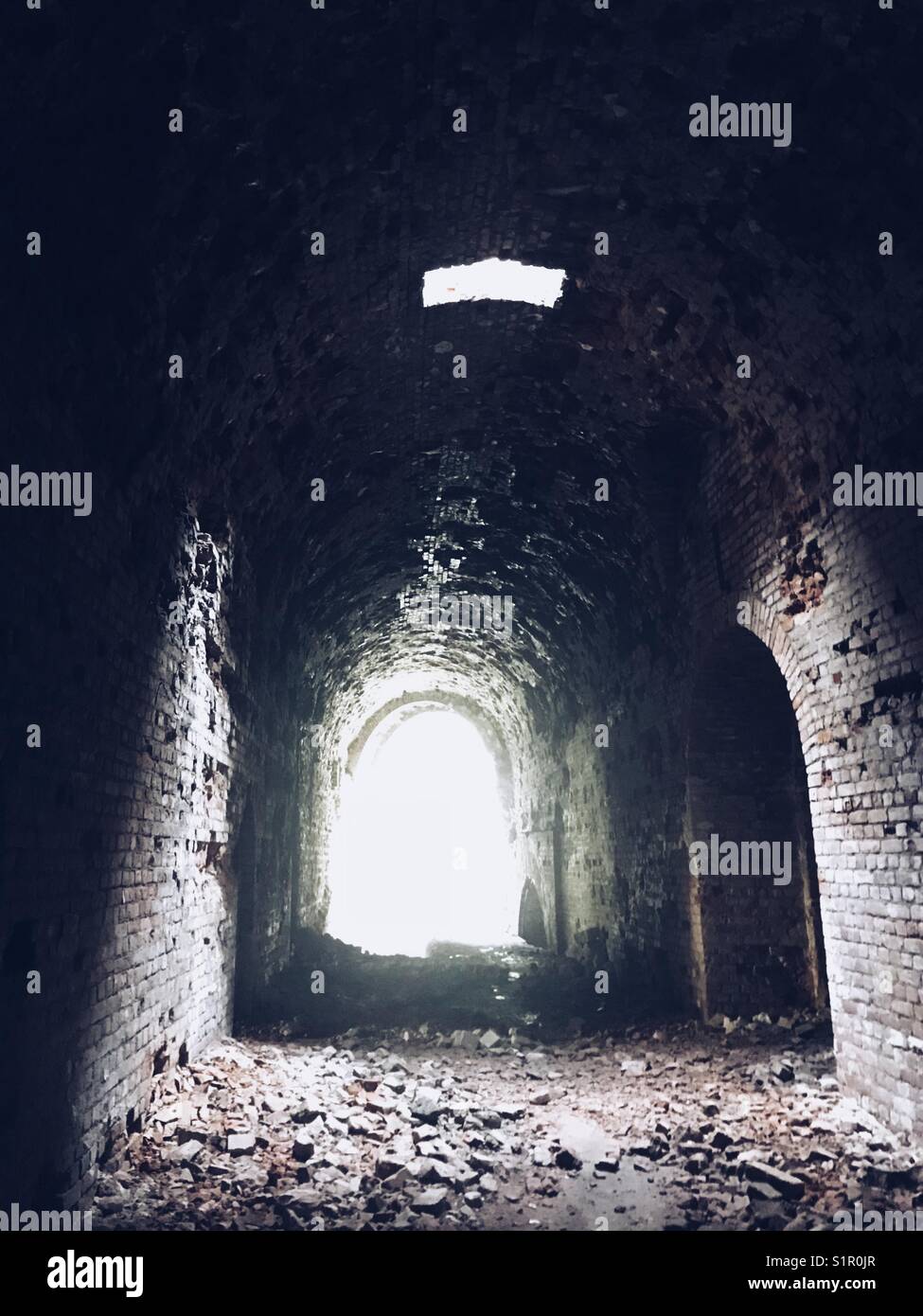 The dimly lit corridor of the Tarakaniv Fort in Lviv, Ukraine - Smartphone Captured Stock Image