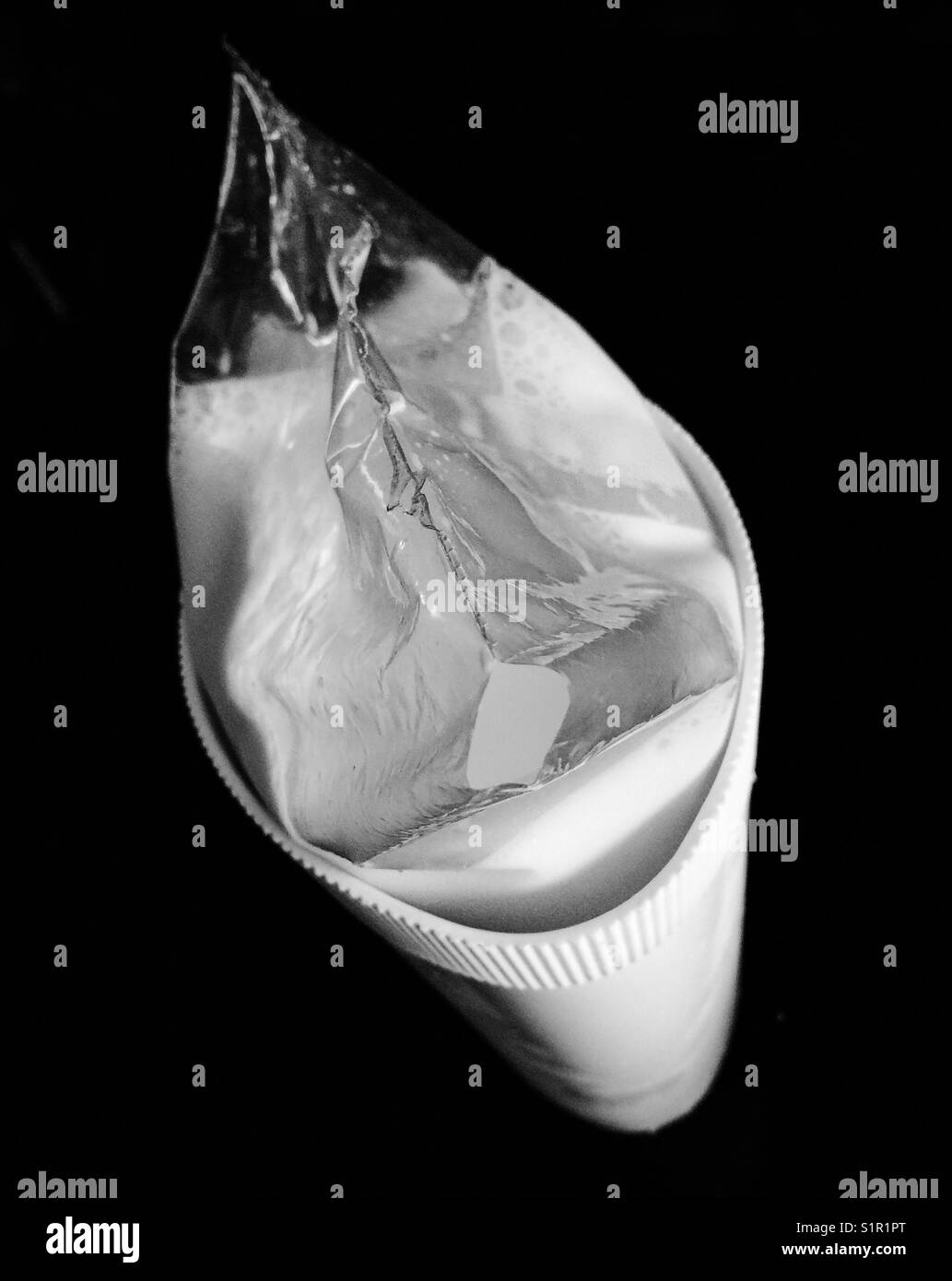 Top view of bag of milk in a pitcher freshly cut - Smartphone Captured Stock Image