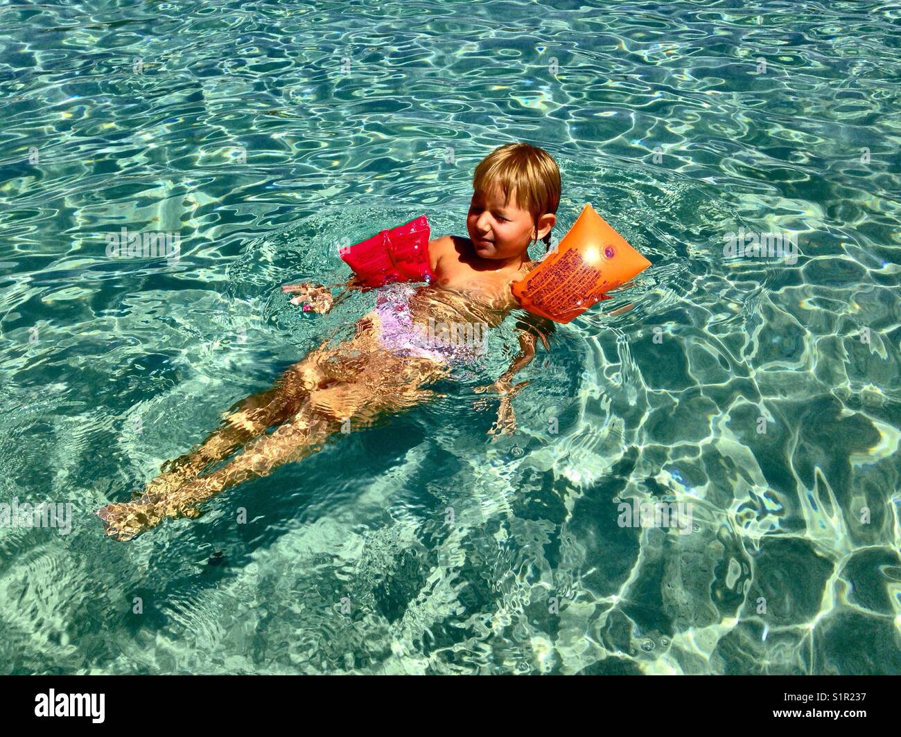 Small girl swiming Stock Photo