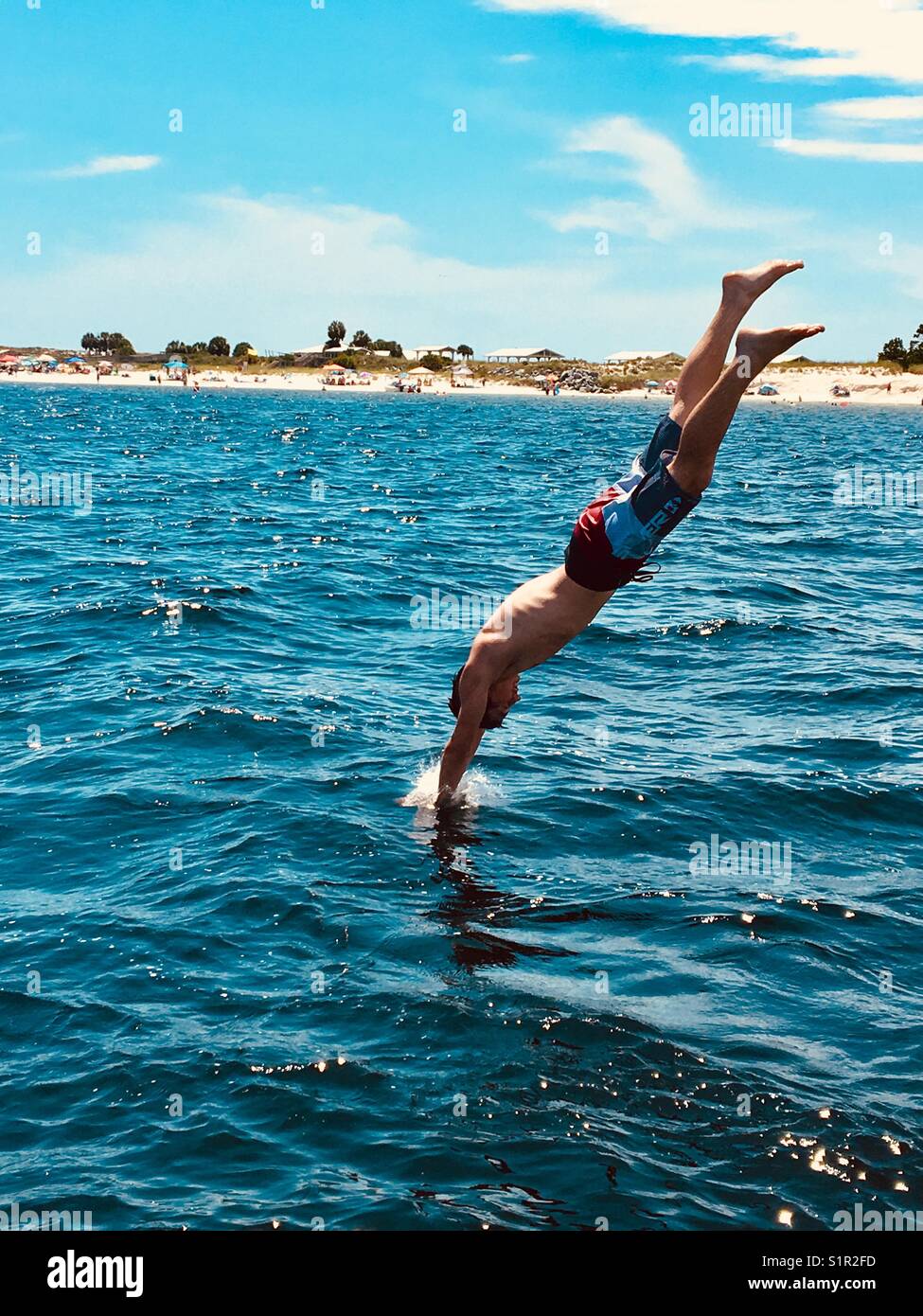 Boy diving into sea hi-res stock photography and images - Alamy