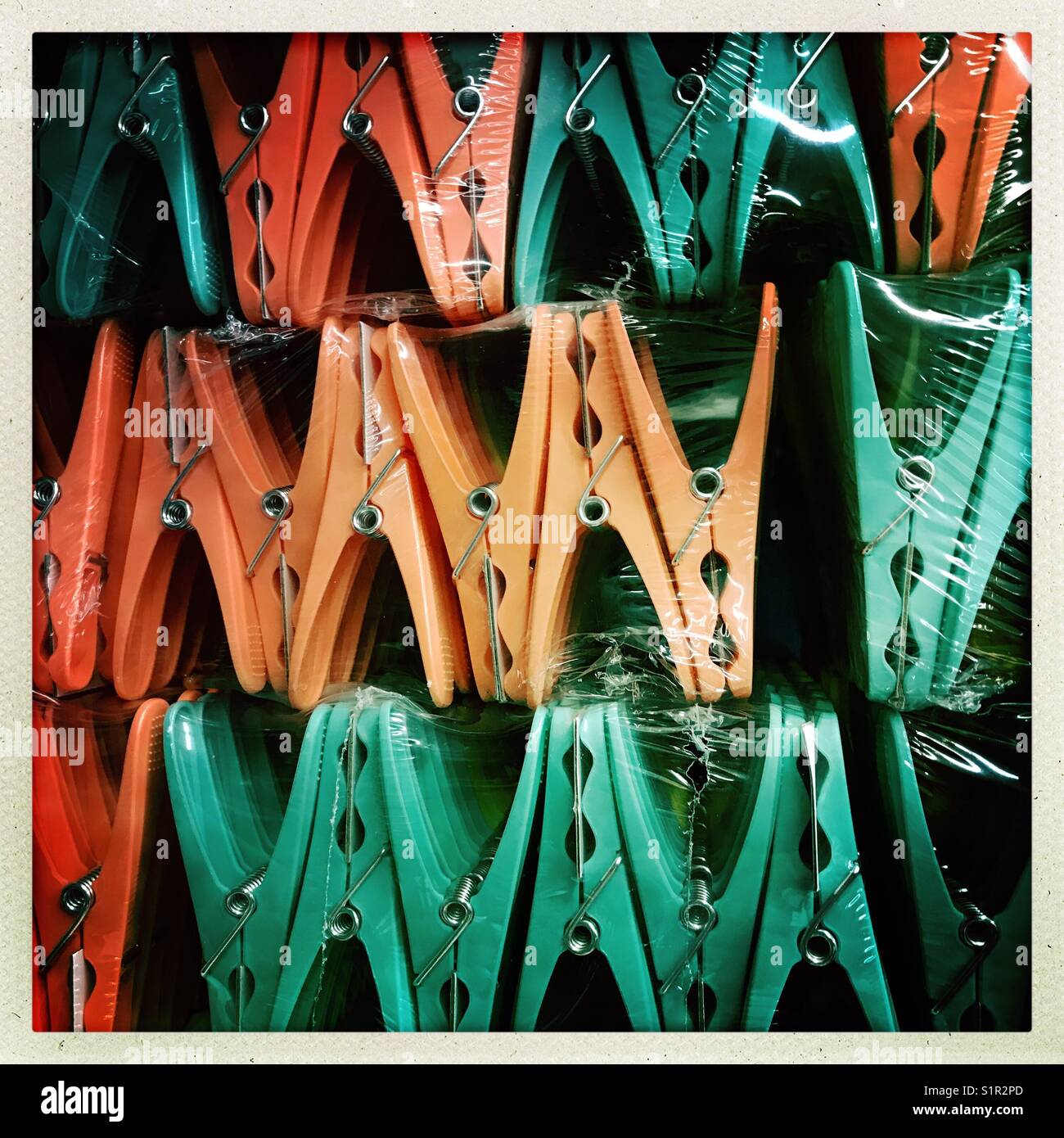 Plastic pegs lined up and ready for sale Stock Photo