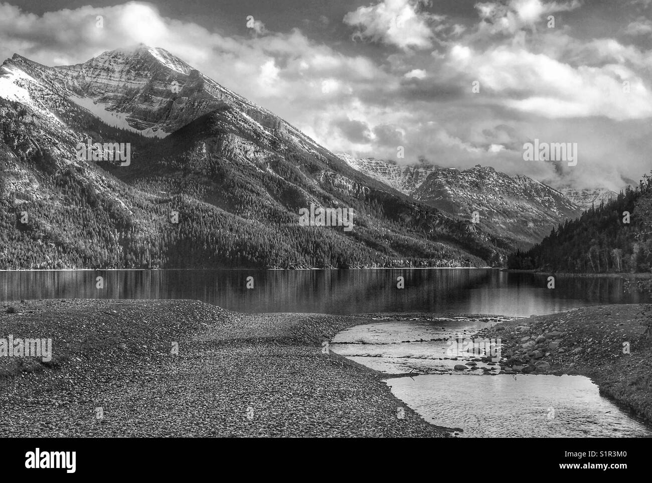 Upper Waterton Lake - looking towards the USA, from the beach by Cameron Creek, in black and white. Waterton Lakes national park, Alberta, Canada. - Smartphone Captured Stock Image Upper Waterton Lake - looking towards the USA, from the beach by Cameron Creek, in black and white. Waterton Lakes national park, Alberta, Canada. - Smartphone Captured Stock Image
