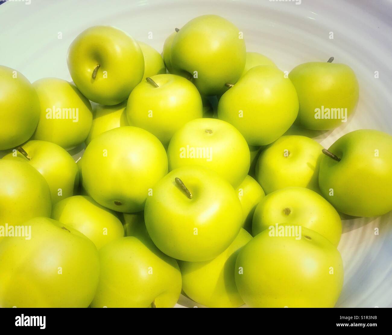 Ceramic bowl filled with green apples Stock Photo Alamy