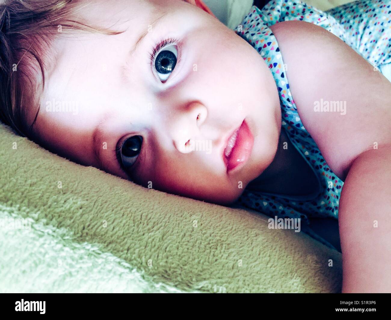 Closeup of baby girl looking at camera Stock Photo