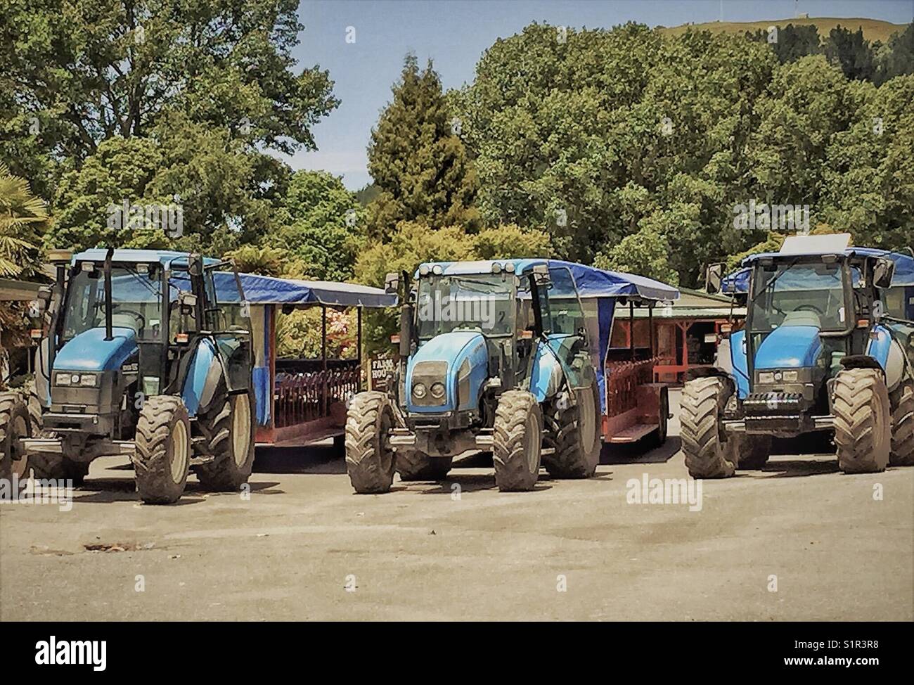 Three rubber tyre tractors parked in the daytime Stock Photo Alamy