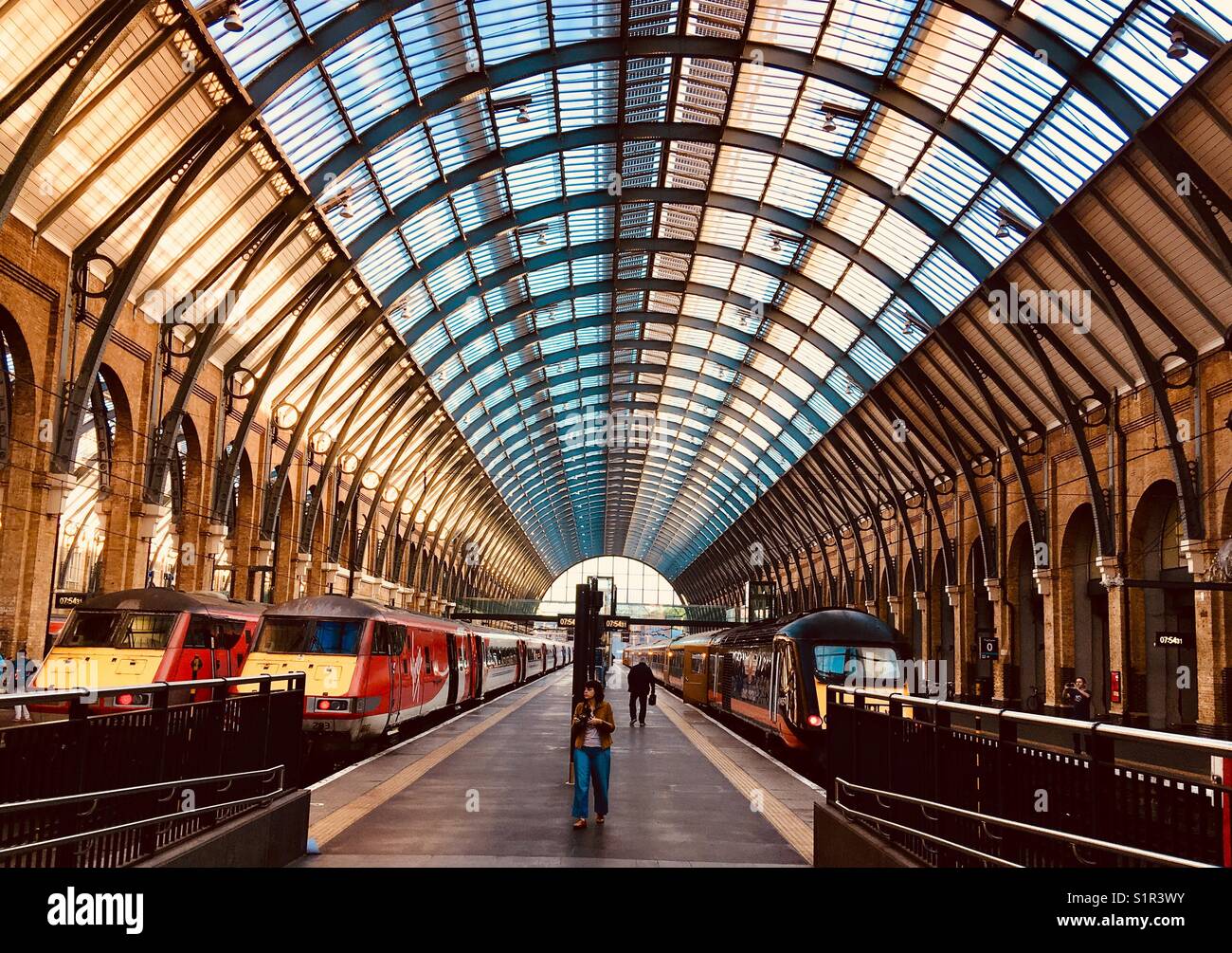 Passengers on a platform at Kings Cross station in London Stock Photo