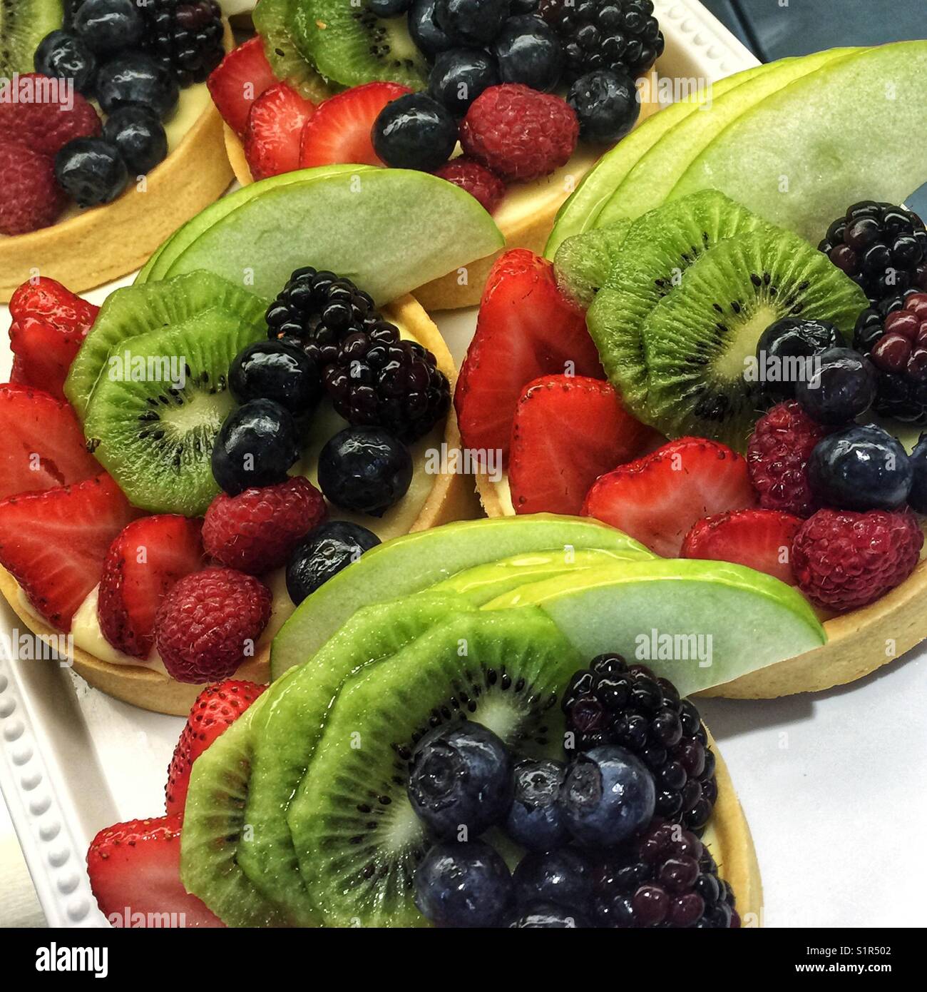 Colorful tarts topped with fruit in a bakery - Smartphone Captured Stock Image