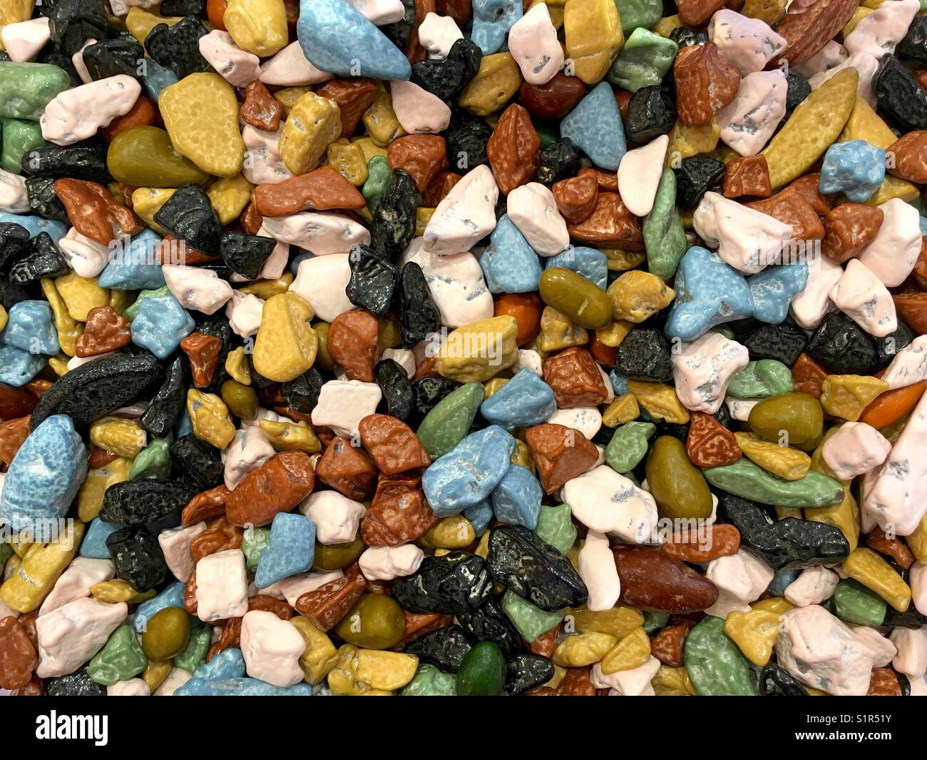Close up on many colorful chocolate rocks candy coated. Top view Stock