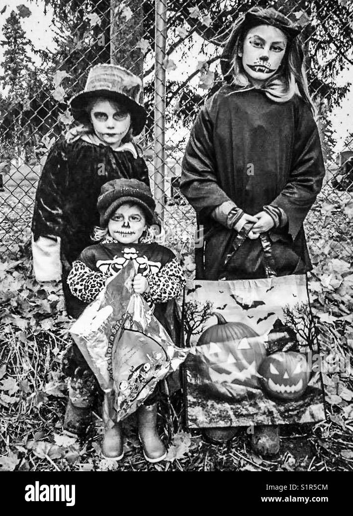 Three children dressed in Halloween costumes - Smartphone Captured Stock Image