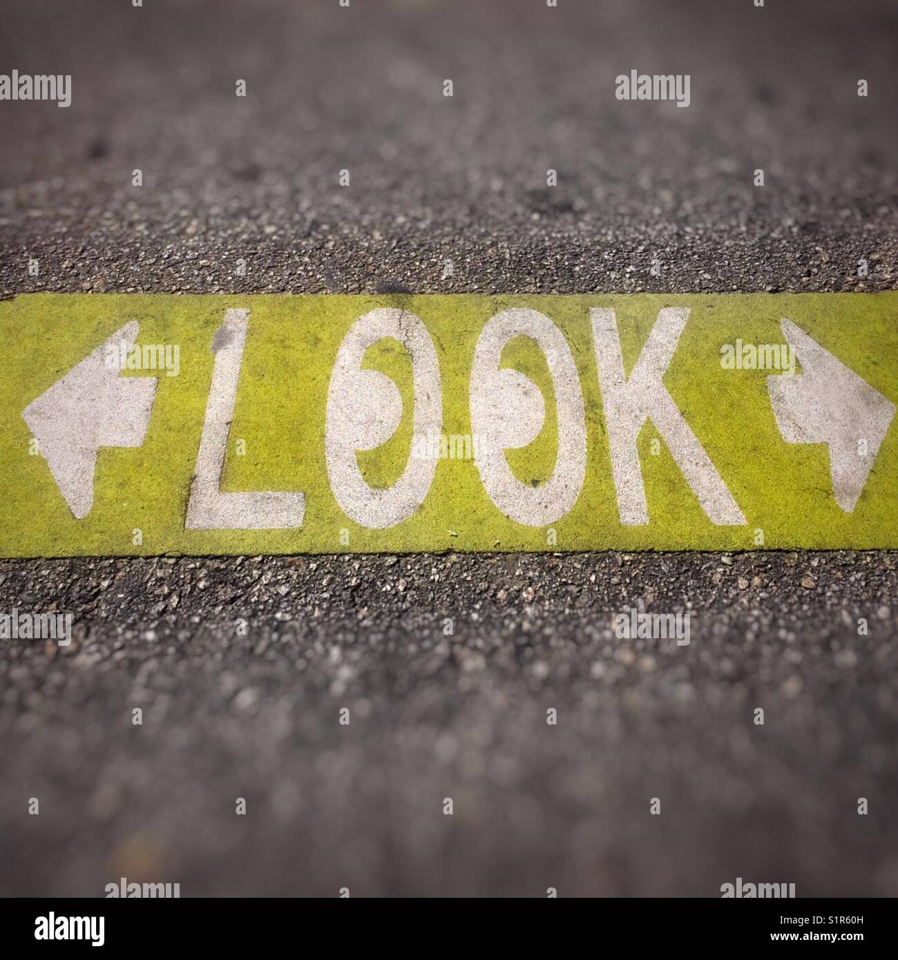 Caution to look both ways street pavement sign - Smartphone Captured Stock Image