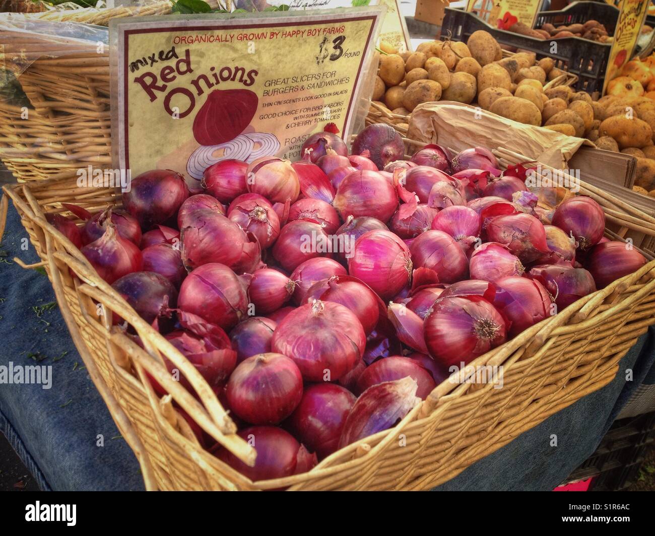 A display of red onions at the Berkeley Farmers Market in Berkeley, California. - Smartphone Captured Stock Image