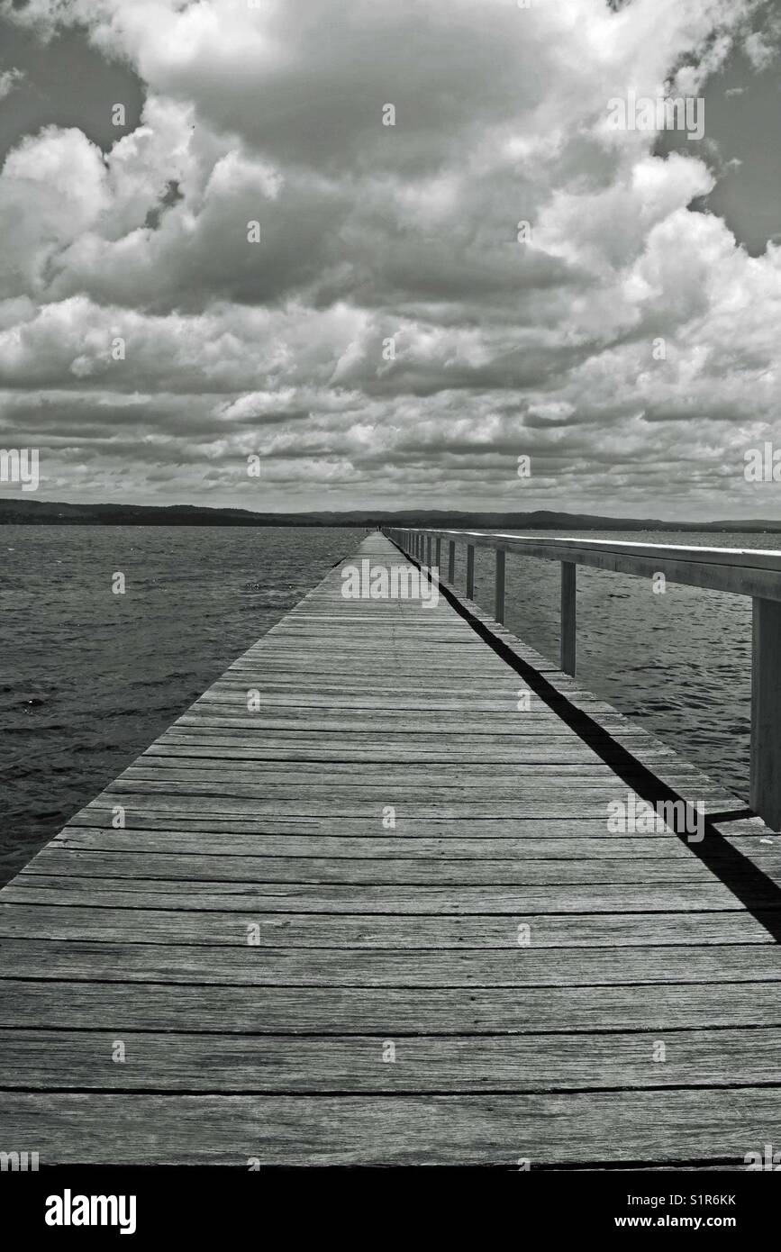 Long jetty over ocean in black and white - Smartphone Captured Stock Image