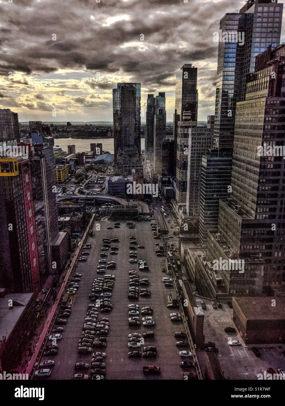 Sunset from elevated floor of the New York Times building, view of parking building at Port Authority bus terminal and Hudson River - Smartphone Captured Stock Image