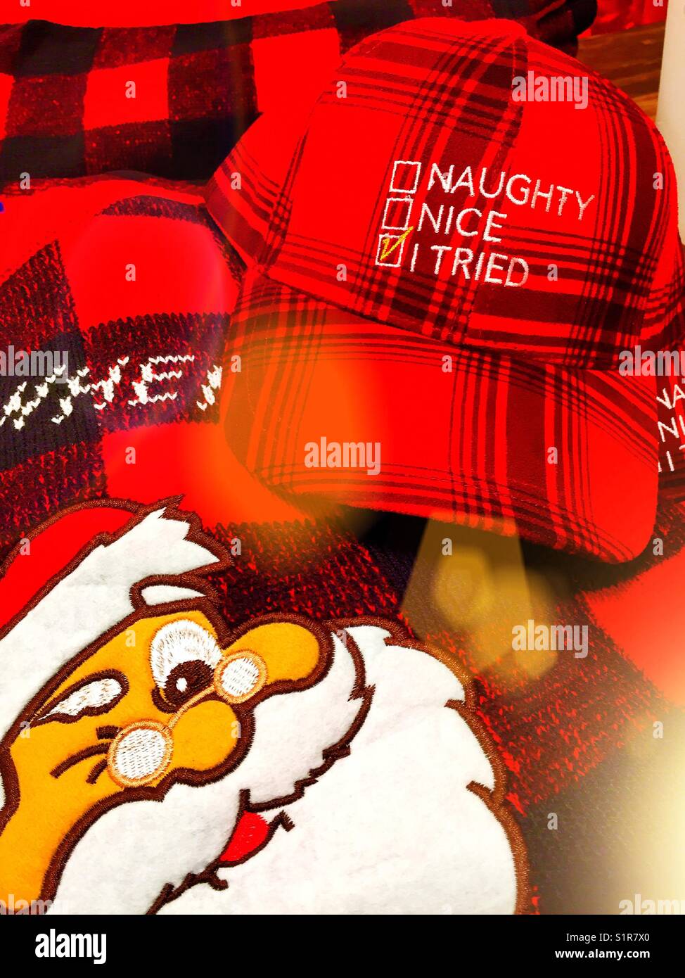 Humorous Christmas display with Santa and plaid hat, USA - Smartphone Captured Stock Image