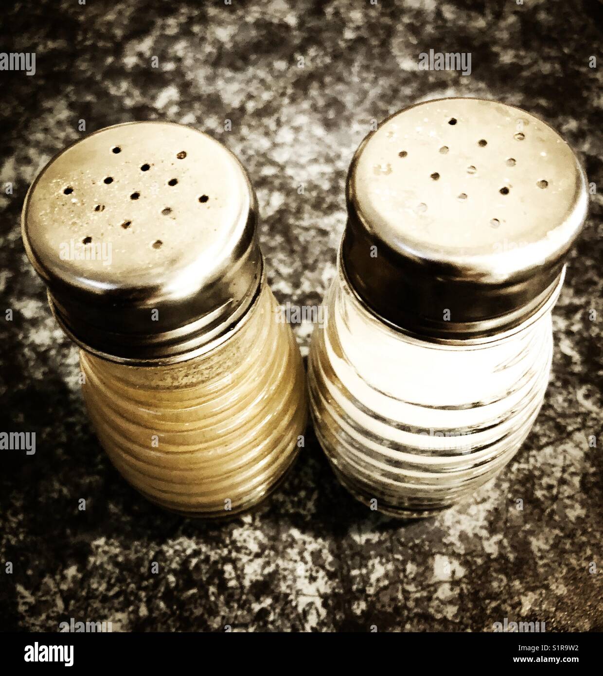 Close up of salt and pepper shakers on a restaurant table - Smartphone Captured Stock Image