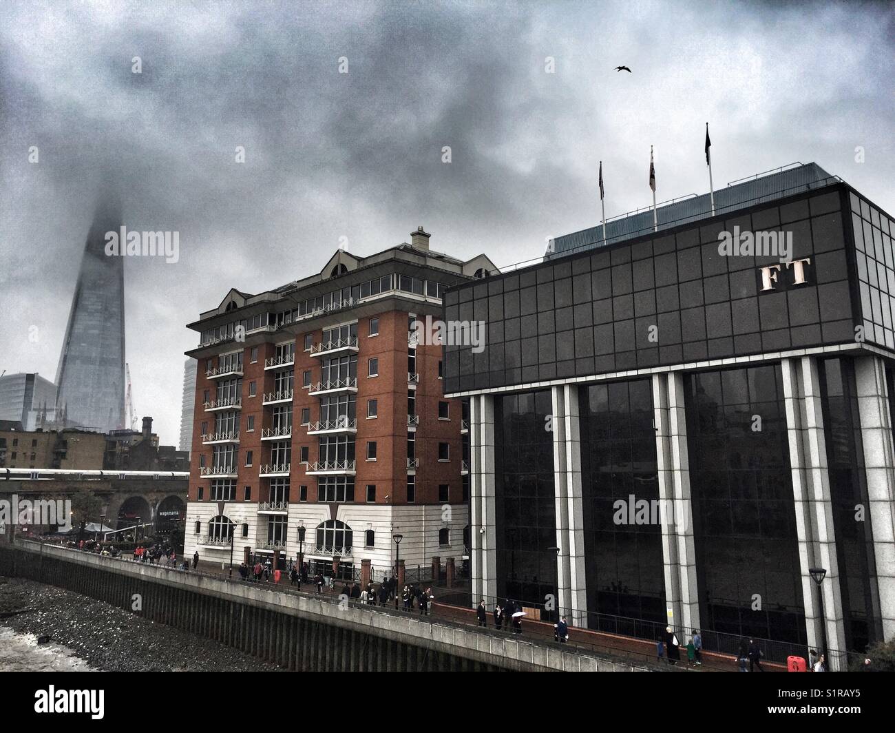 The Shard is seen masked by fog and the Financial Times office on Southwark Bridge in London, England - Smartphone Captured Stock Image