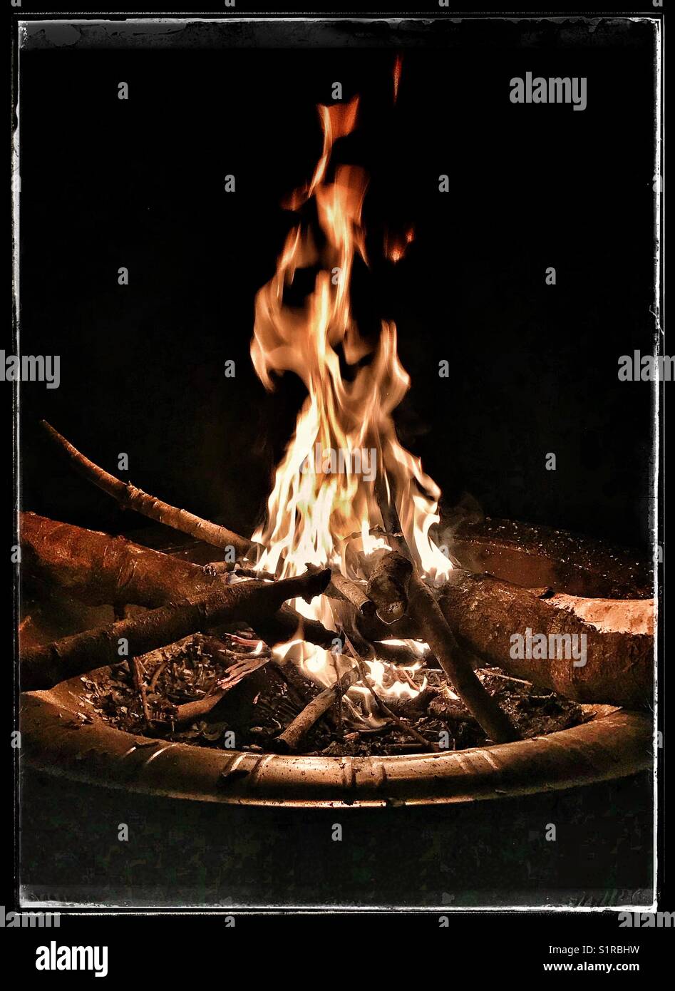 Outdoor wood fire at night - Smartphone Captured Stock Image
