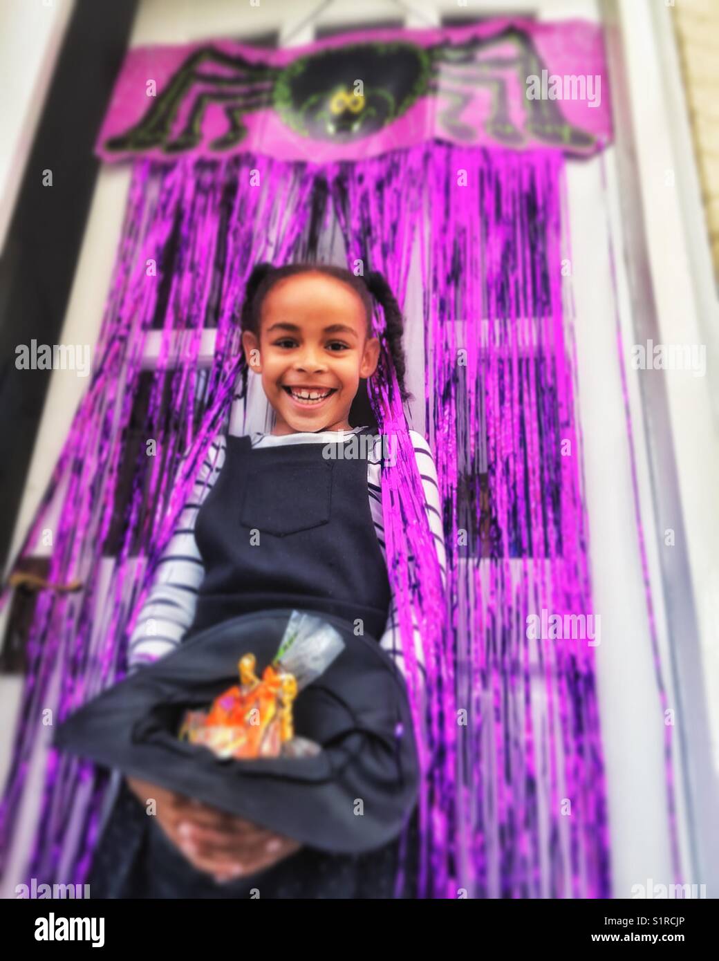 A laughing girl enjoying Halloween. - Smartphone Captured Stock Image