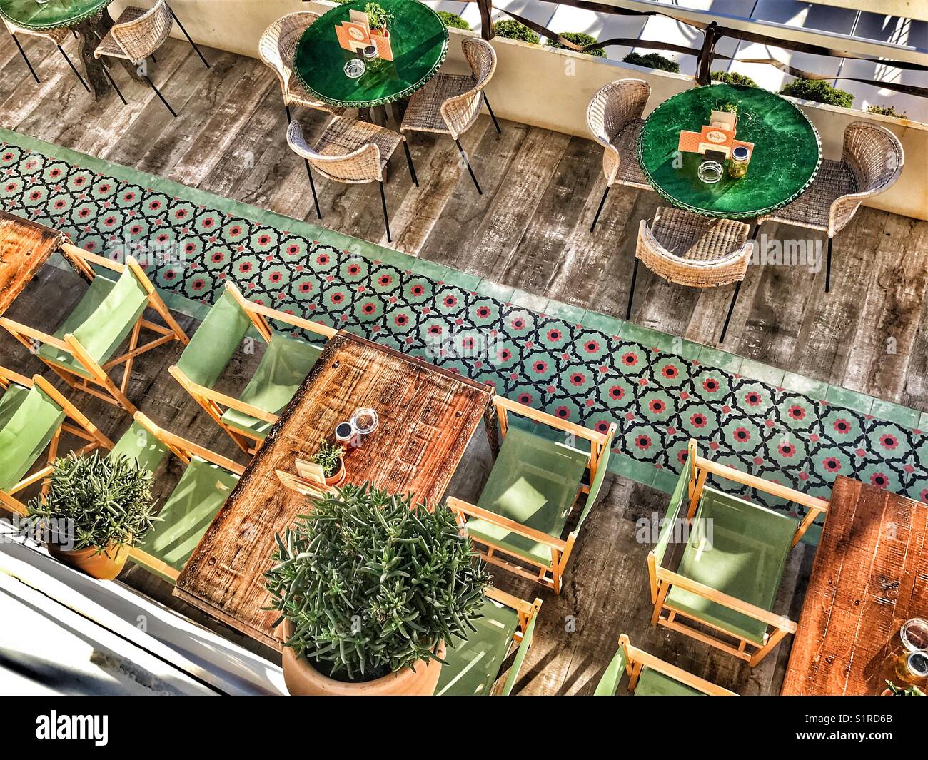 Tables and chairs, outdoor terrace of a restaurant, high angle view, Spain - Smartphone Captured Stock Image