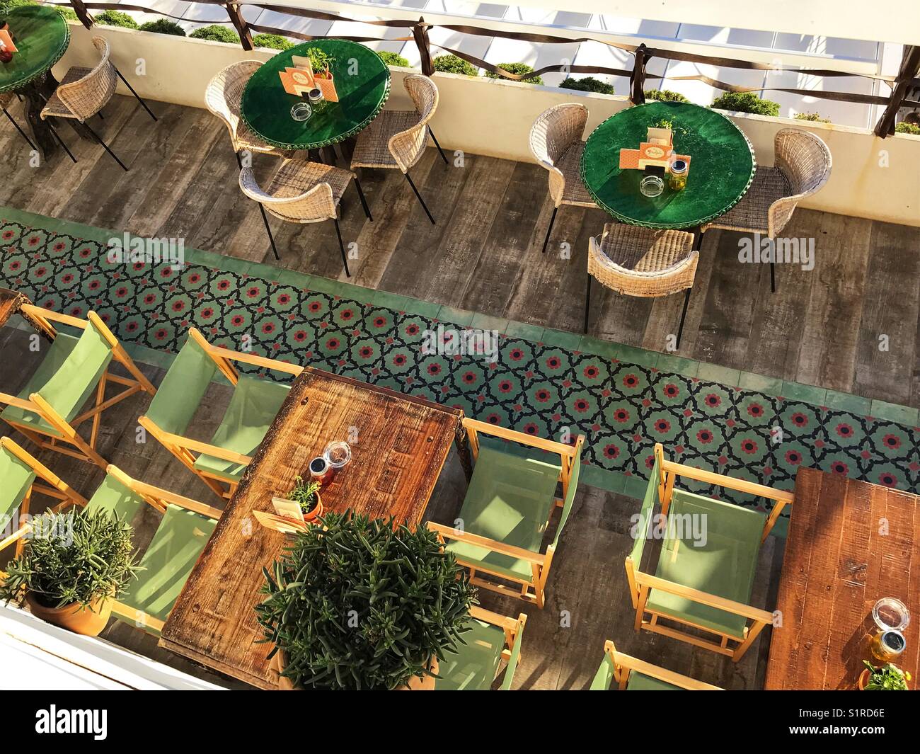 Tables and chairs, outdoor terrace of a restaurant, high angle view, Spain - Smartphone Captured Stock Image