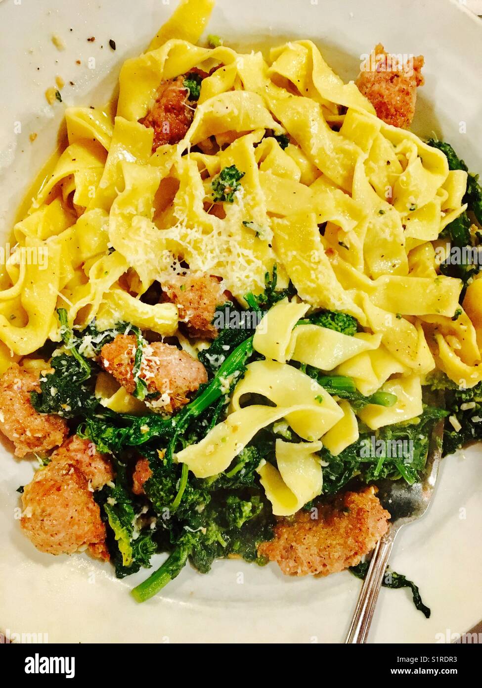 Plate of fresh made pasta with sausage and broccoli rabe Stock Photo
