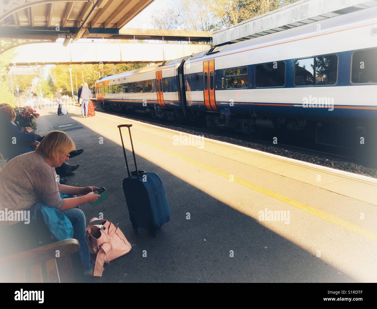 Passengers on rail station platform,  waiting for a train, - Smartphone Captured Stock Image