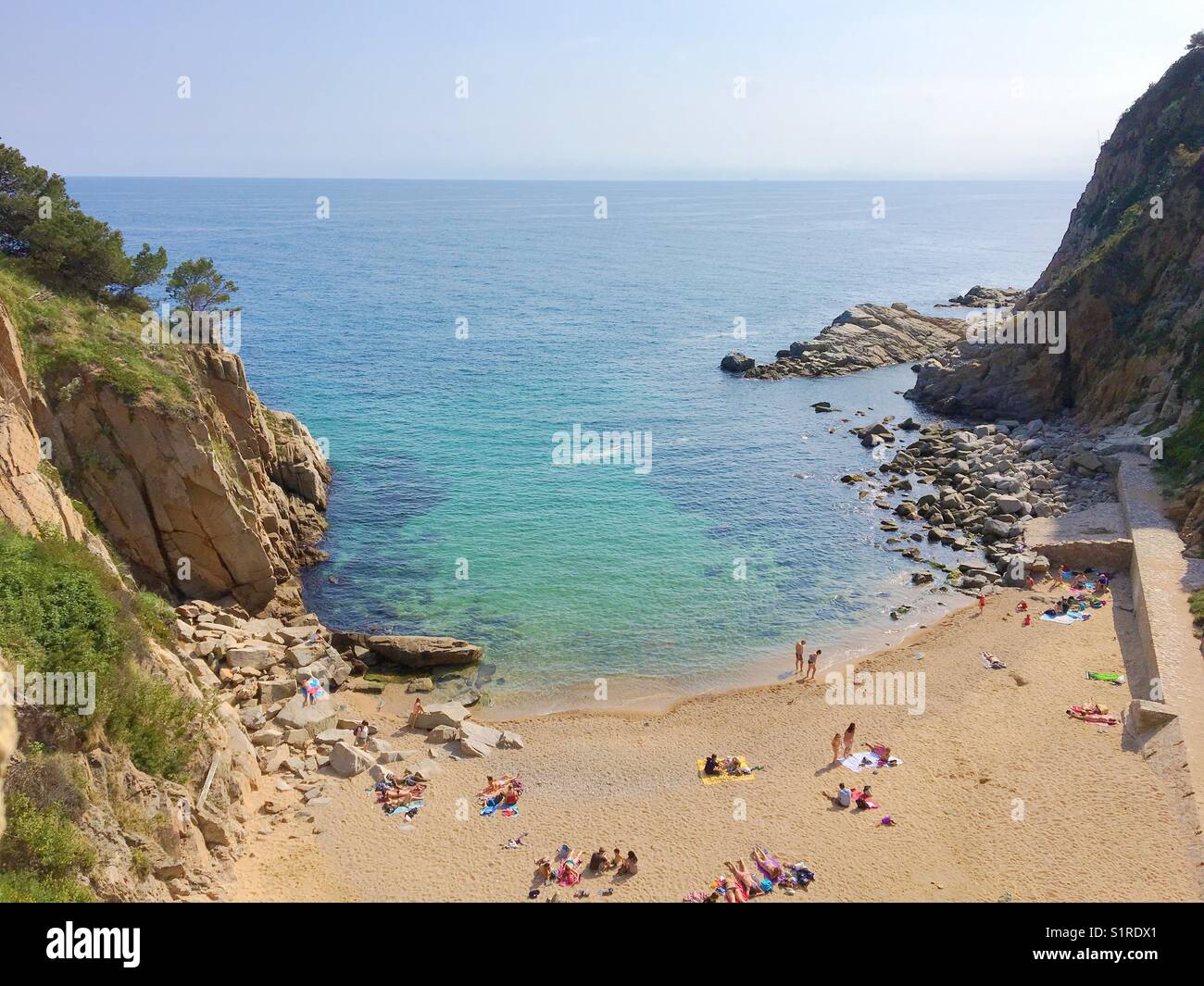 A Spanish sandy cove beach on the Costa Dorada overlooking the Mediterranean Sea Stock Photo