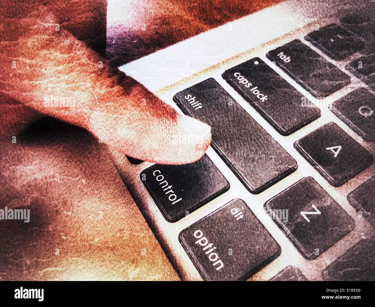 Finger above the Control key on a laptop computer keyboard - Smartphone Captured Stock Image
