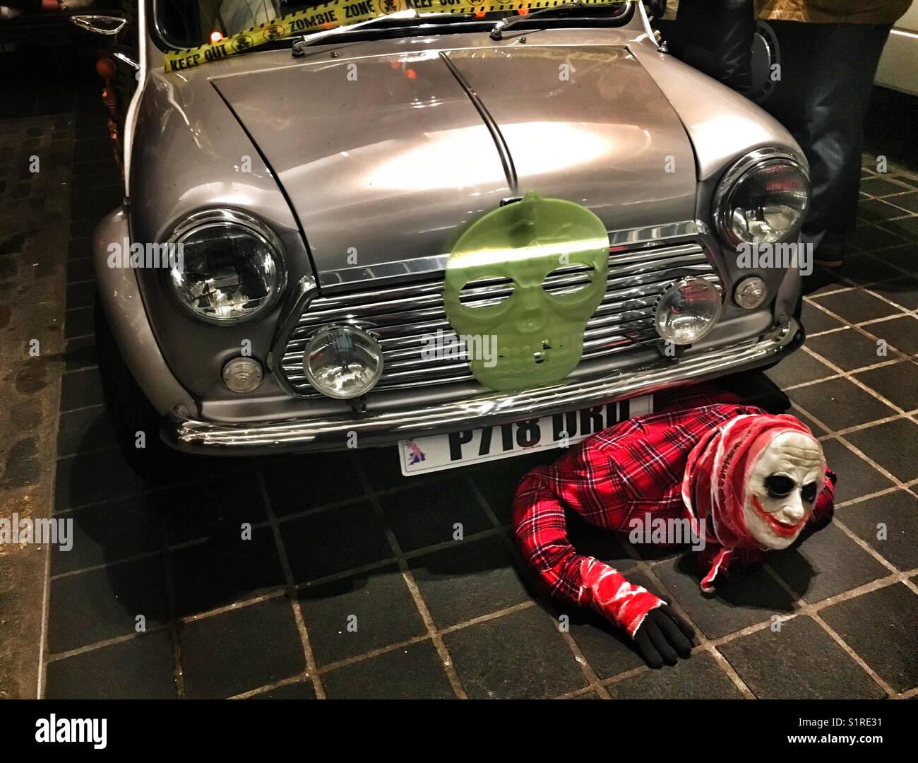 Halloween monster climbing out from under s car - Smartphone Captured Stock Image