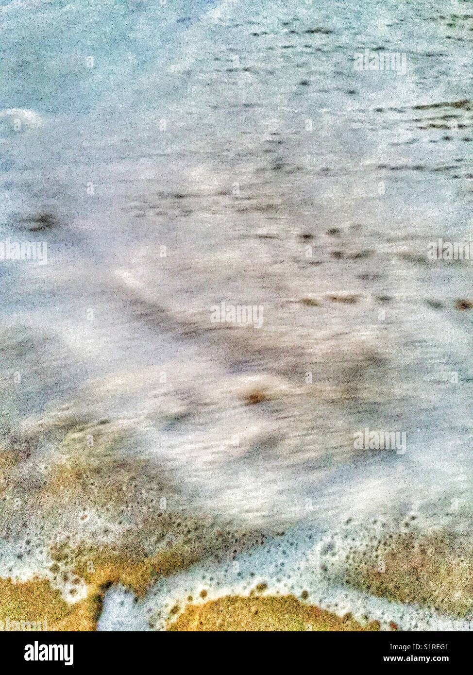 Sea foam on the beach. - Smartphone Captured Stock Image