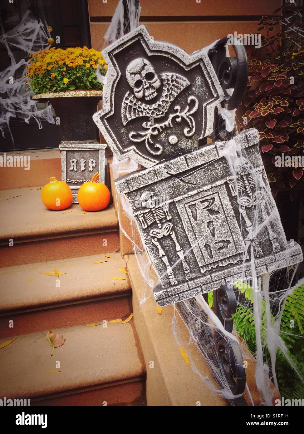 Halloween Display on brownstone stoop steps front door, New York City, USA - Smartphone Captured Stock Image