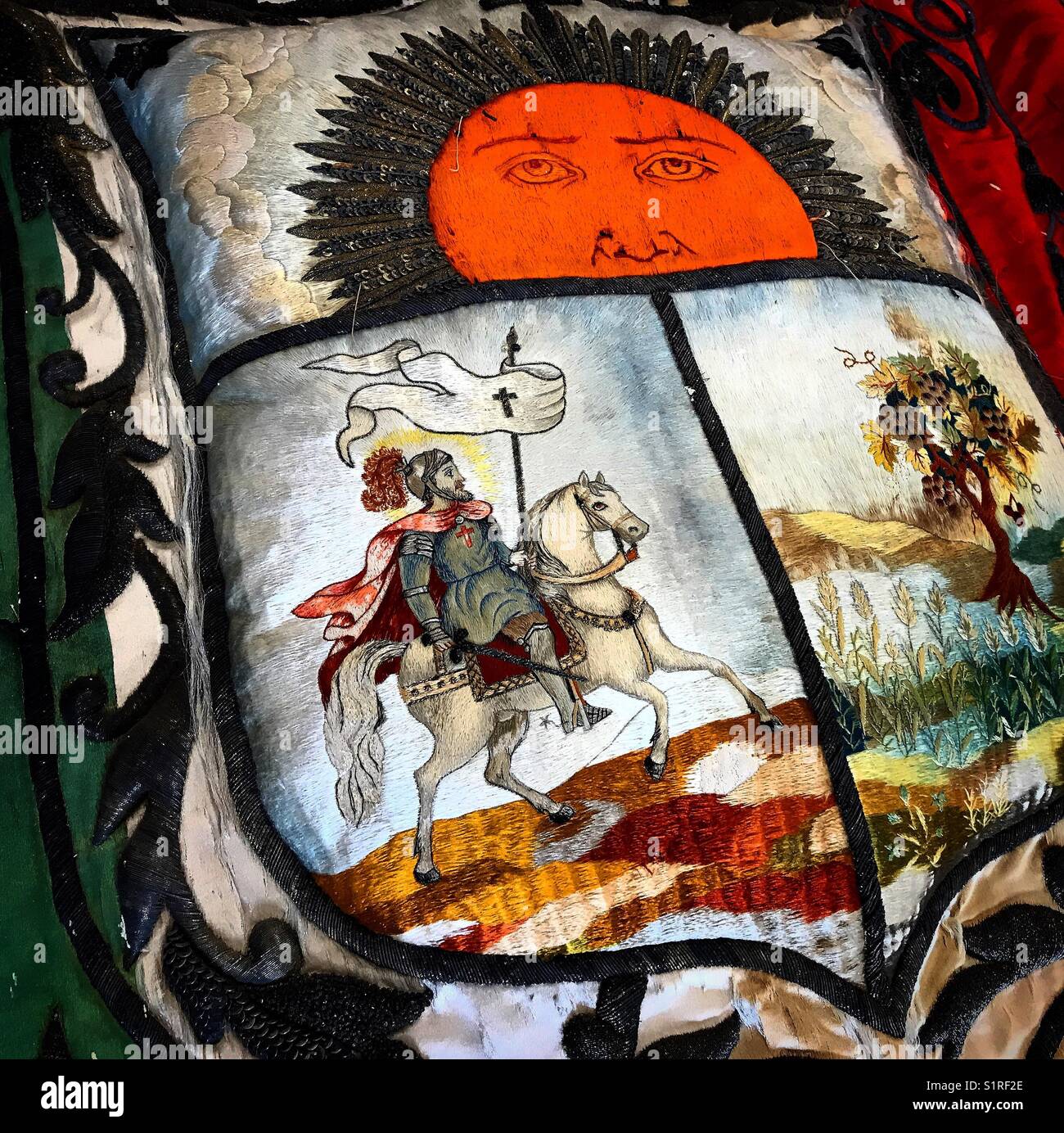 A cushion with the coat of arms of the city of Santiago de Queretaro shows a rising sun, a tree and Saint James Apostle in Museo de Arte Sacro museum in Queretaro, Mexico Stock Photo