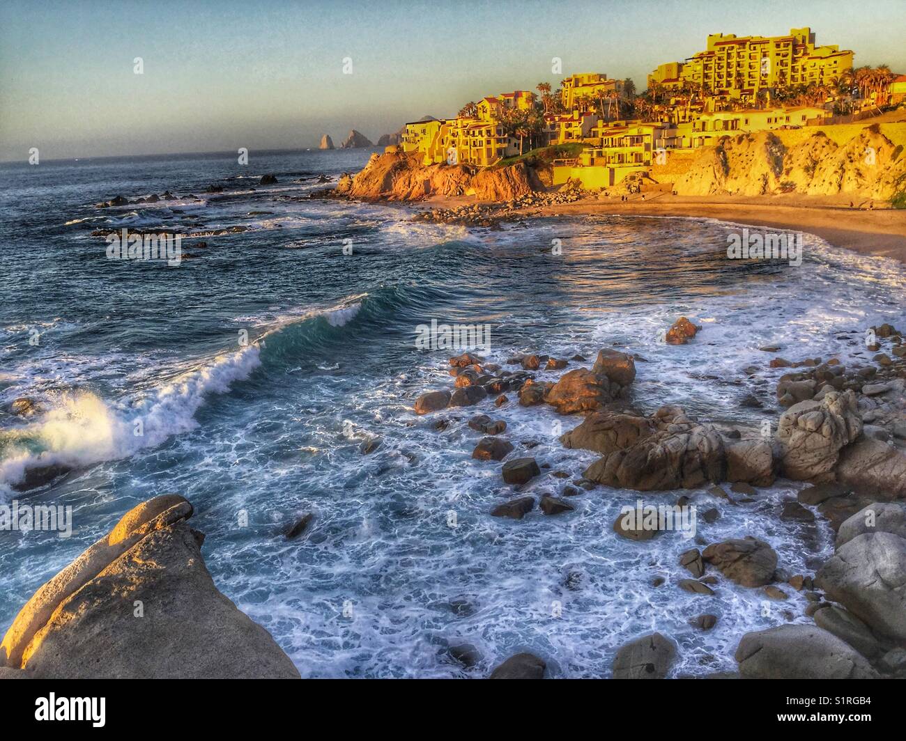Evening glow on the rugged coastline looking towards the infamous Arch in Cabo San Lucas, Mexico. Stock Photo